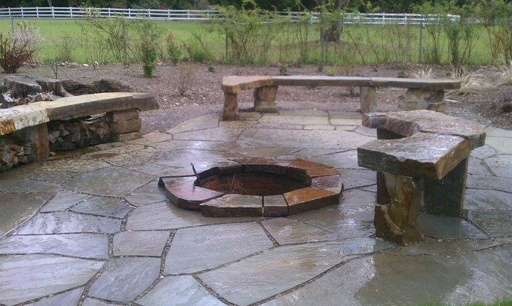 Stone patio with fire pit and benches