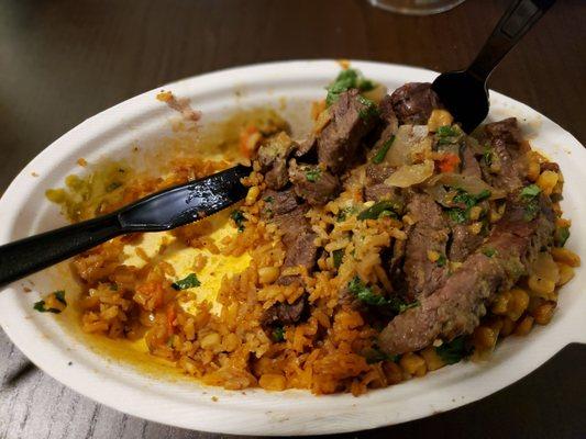 Half eaten, sorry. Double carne asada, extra Mexican rice, roasted corn, peppers & onions, AMAZING poblano crema, double cilantro.