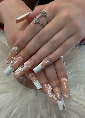 Long Nude and French Acrylic Nails with Crystals and Flower Designs