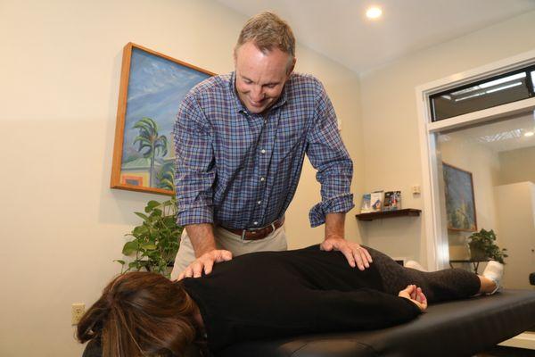 Dr. Bissell performing manual stretches. This will loosen up the spinal muscles which increases mobility and flexibility