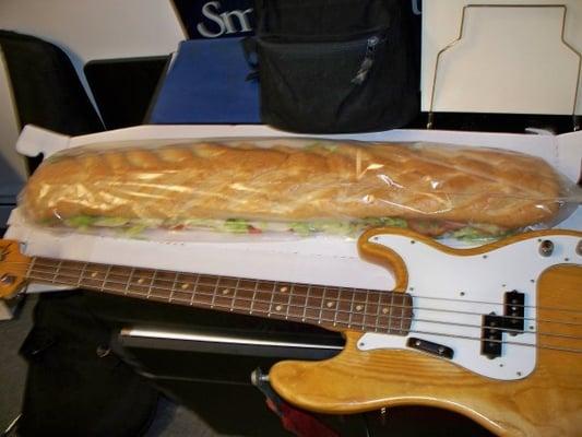 their three-foot sandwich is almost as big as a bass guitar