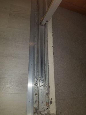 Bottom track of sliding glass door.