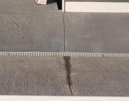 wavy and asymmetrical stress lines cut into the concrete