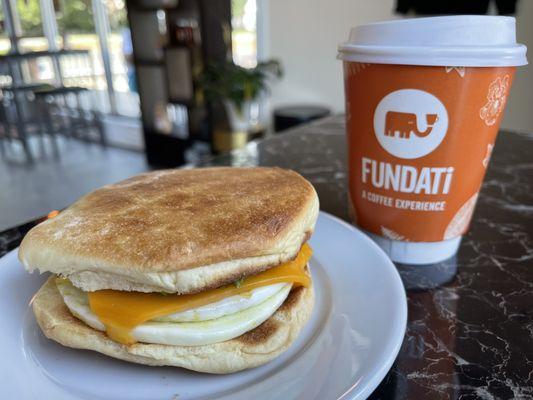 Egg and cheddar with avocado on a Portuguese bolo roll and a vanilla Chai latte.