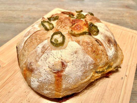 Jalapeño Cheddar Sourdough Loaf. Spicy and fresh with globs of cheese found throughout the bread.