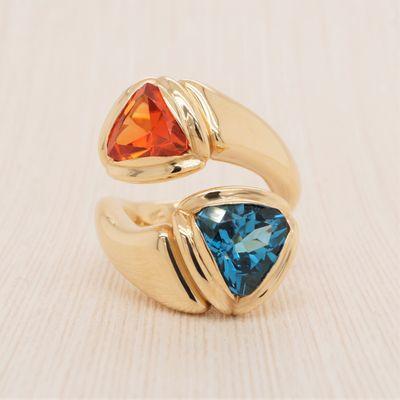 Trillion cut mexican fire opal and london blue topaz ring, handmade with a sleek finish.