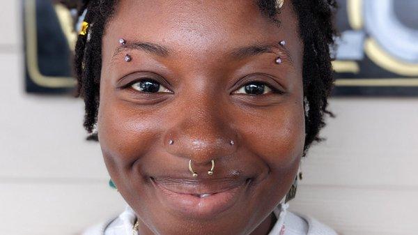 Paired brow piercings with lavender opal curves from NeoMetal! Pierced by Meghan, and styled by Brandi!