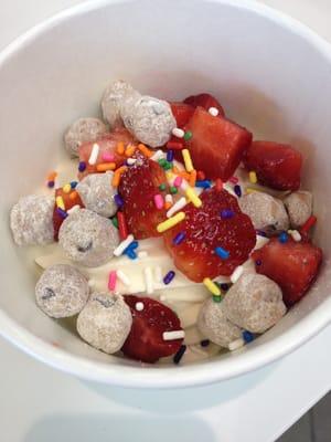 Vanilla yogurt with cookie dough, strawberries, and rainbow sprinkles