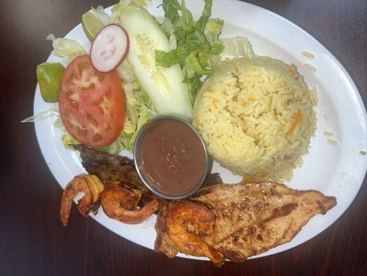 Grilled Chicken, shrimp, and beef with a side of tortilla and beans and their white rice