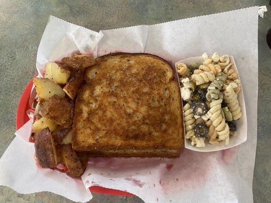 Patty melt with home fries and Greek pasta salad