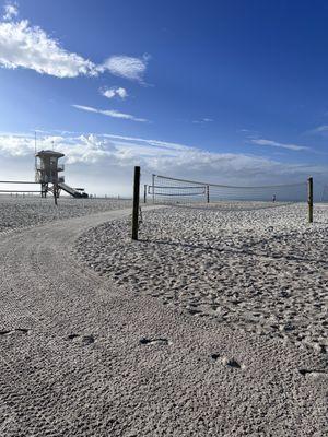 Groomed path, volleyball nets, lifeguard tower