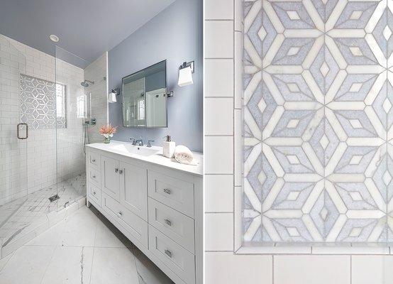 Refresh and renew your bathroom this year! Geometric tiling highlights a wall feature in this walk-in shower with oversized marble tile.