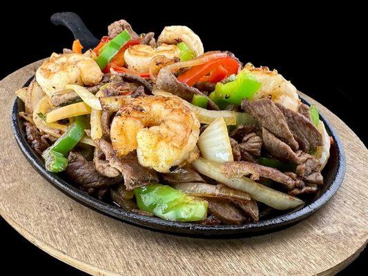 Succulent shrimp and tender steak strips, sizzled with bell peppers and onions.