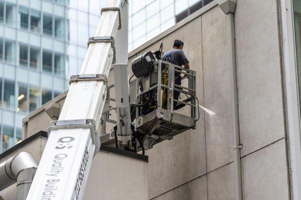 Power washing , steam cleaning and restoring the exterior of New York's  buildings made of stone, metal, marble, wood, using a boom truck