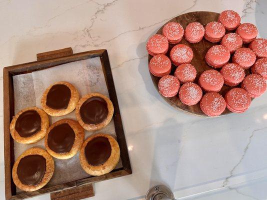 Boston cream brioche on the left and macaroons on the right.