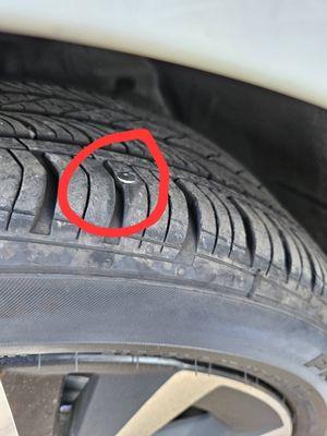 Driver front tire has a nail,