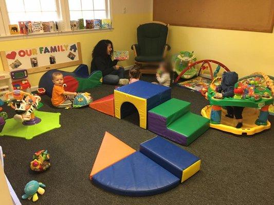 Story time in the infant room helps build language, socialization and listening skills!