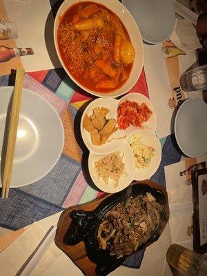 Spicy rice cake, bulgogi, not sure why we get different sides compare to the other table