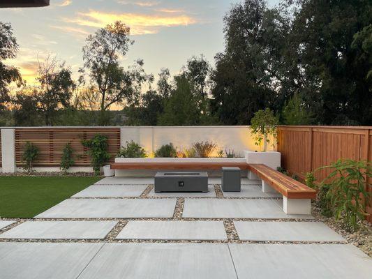 Backyard Remodel including bench, concrete, artificial turf, masonry planters, low maintenance landscaping and low voltage lighting.