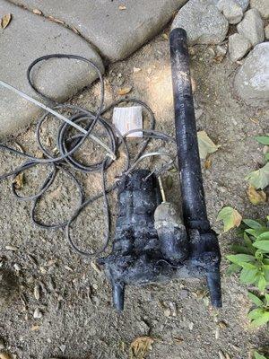 Old sump pump that failed and needed to be replaced causing an emergency situation