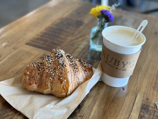 Coffee with an everything bagel, stuffed cream, cheese croissant.