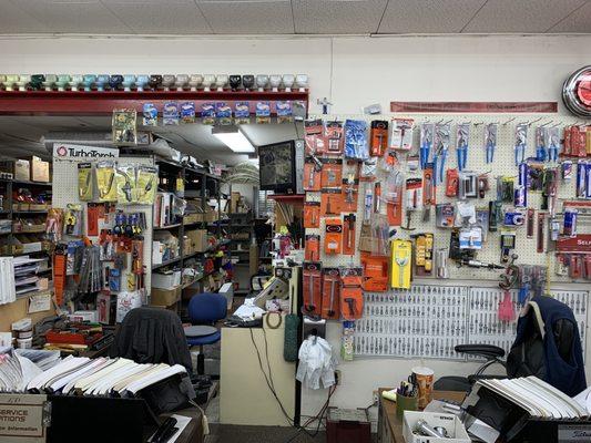 Behind the counter: Plumbing wrenches of all types and sizes. Plus a collection of Hot Wheels toilet cars. Rare indeed.