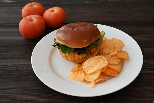 Platter or box lunch. Crispy chicken sandwich on brioche roll with choice of cheese, ripe tomato & seasonal green.