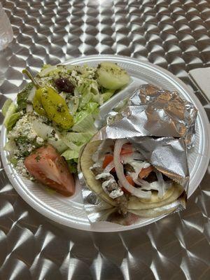 Gyro sandwich and Greek salad