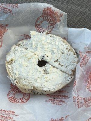 A bagel with little no cream cheese