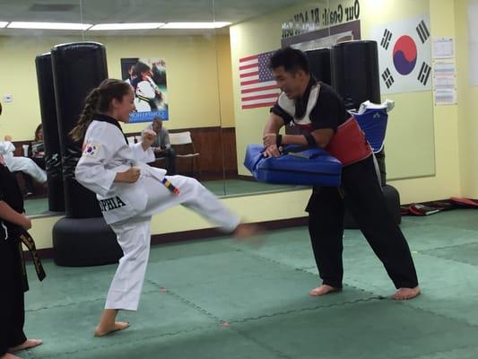 Practicing her front kick with Master Yu