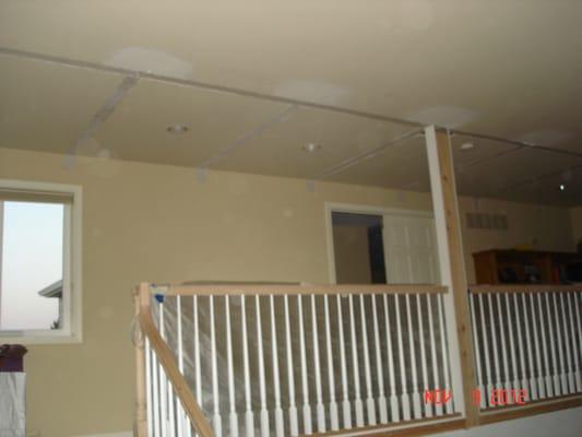 False beams taken out of ceiling. Drywall was taped and textured to match existing.