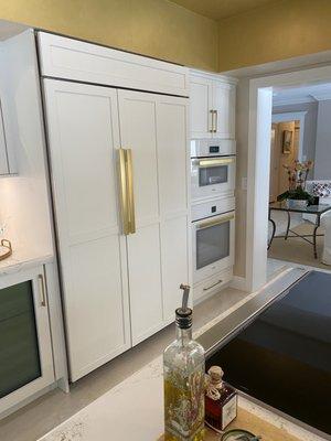 Sub zero refrigerator, Mile oven and speed oven,  gold handle from Mile. Wine cooler, Wolfe induction electric stove.