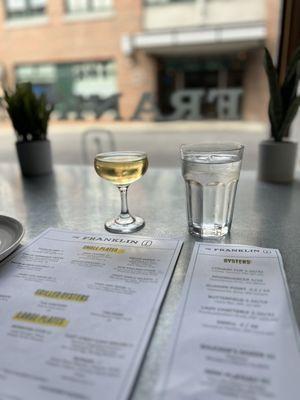 The set up with the happy hour $5 sparkling wine. Cute glasses.