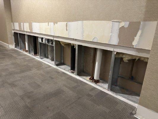 Hallways have been missing moulding and dry wall for over 3 years after a rooftop flood.