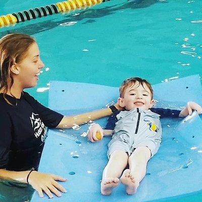 Richie is learning to float on his back with help from Miss Madonna.