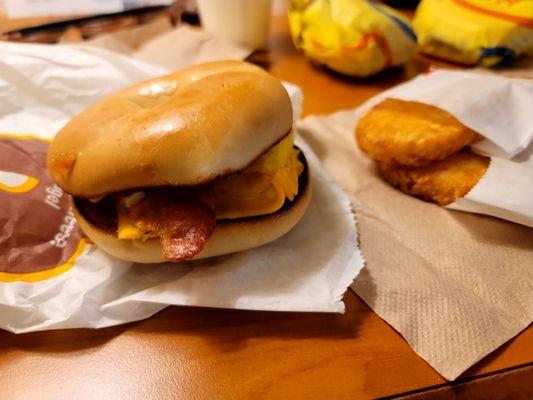 Bacon, egg, and cheese bagel with hashbrowns