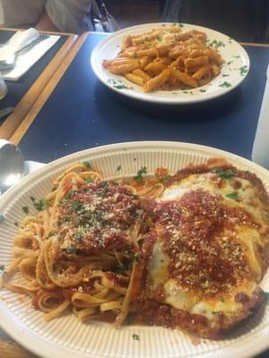 Eggplant parmigiana with penne vodka in the background