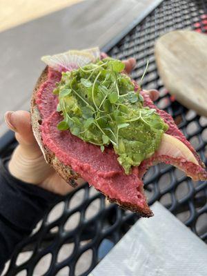 Micro greens, avocado smash, watermelon radish, beet hummus all on whole grain sourdough yum!