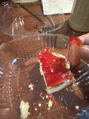 Strawberry cheesecake with a rotten strawberry