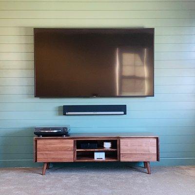 75" Sony TV with Sonos Playbar, Sonos sub, Sonos amp for the rear in-ceiling speakers, and Sonos Connect for the turntable.