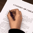 hand filling Custody of Child document