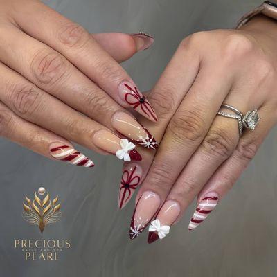 Candy canes, snowflakes, and glittery bows - Christmas nail art has never been this cute! Call us today for a festive manicure.