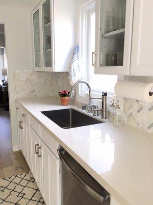 Painted the existing cabinets (saved a TON of money), new sink, counter, and backsplash