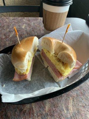 Egg, ham and cheese on a toasted plain bagel. With a medium coffee.