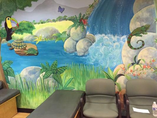 Beautiful murals in the waiting room as well as child-sized furniture. Very kid friendly and colorful