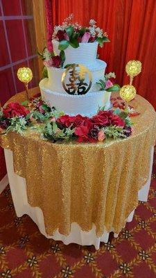 Three layer cake with red and pink flowers. We provided the round double happiness sign and extra items on the table.