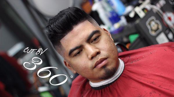 Mid level skin fade with pompadour.  Cut by 360.