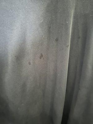 Oil stains on the back of the shirt - didn't exist when I brought the shirt .