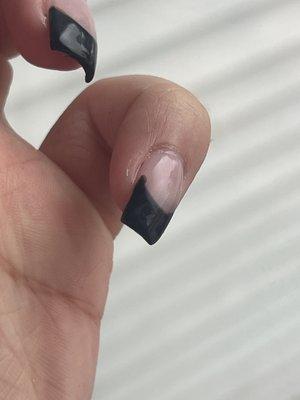 sloppy corners of black frenchie nails