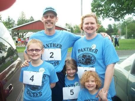 Dr. Todd & Eugena Austin with their girls before a 5K Run/Walk event which they both sponsored and participated in.